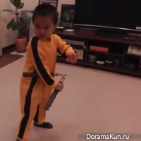 the child imitates Bruce Lee